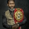 Image of Lovemore N'dou holding his boxing championship belt.