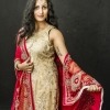 Image of a woman, Mannie Kaur Verma, wearing a gold dress with red shawl.